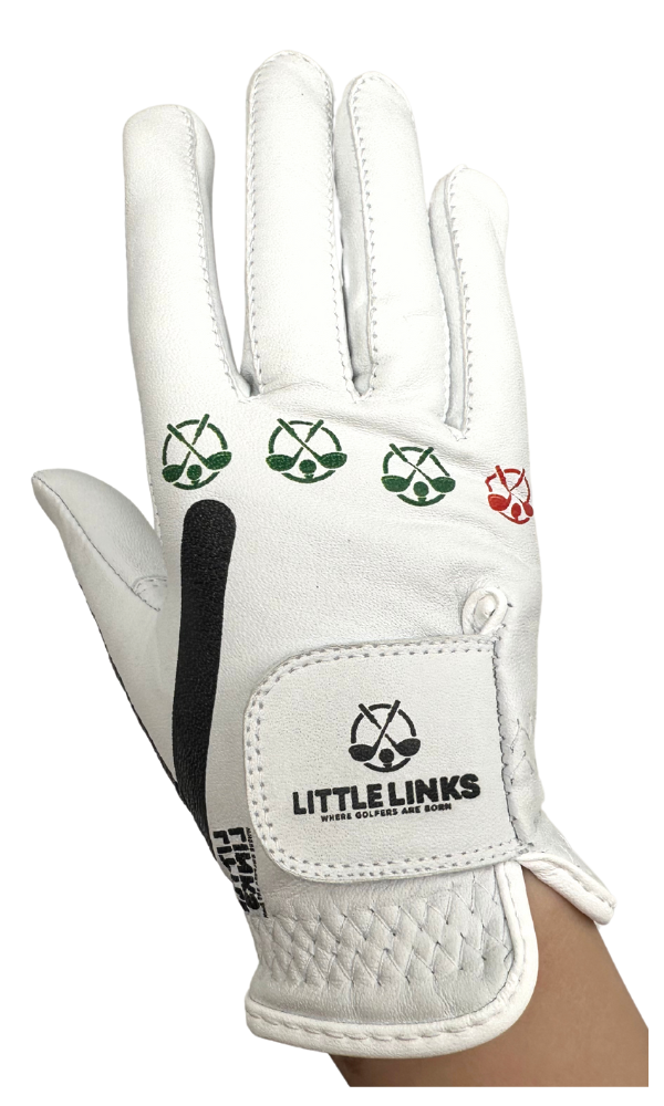 Little Links kids golf training glove for right hand in white shown in a front view on a child’s hand, highlighting the printed grip alignment icons, brand logo, and adjustable wrist closure designed to help young golfers develop proper hand positioning and build confidence while learning the game.