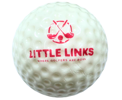 Close-up of Little Links kids foam golf ball in white with pink logo, showing soft texture and oversized design ideal for beginner golf practice.