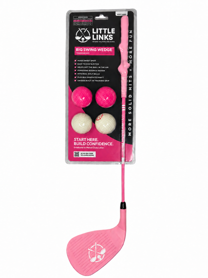 Pink Little Links Big Swing Wedge training club shown in retail packaging with practice balls and oversized club head on a white background.